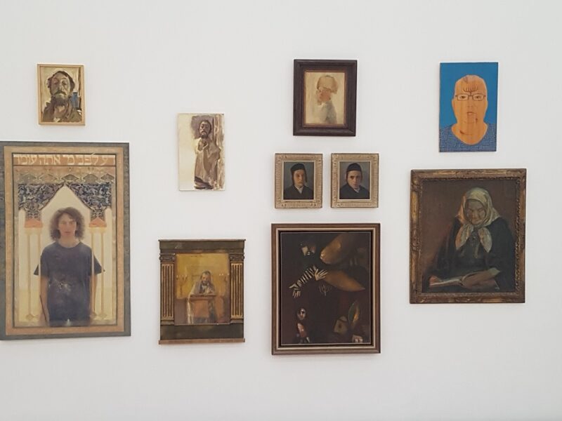Wall of paintings from the exhibition "Chada Knishta" at Ein Harod