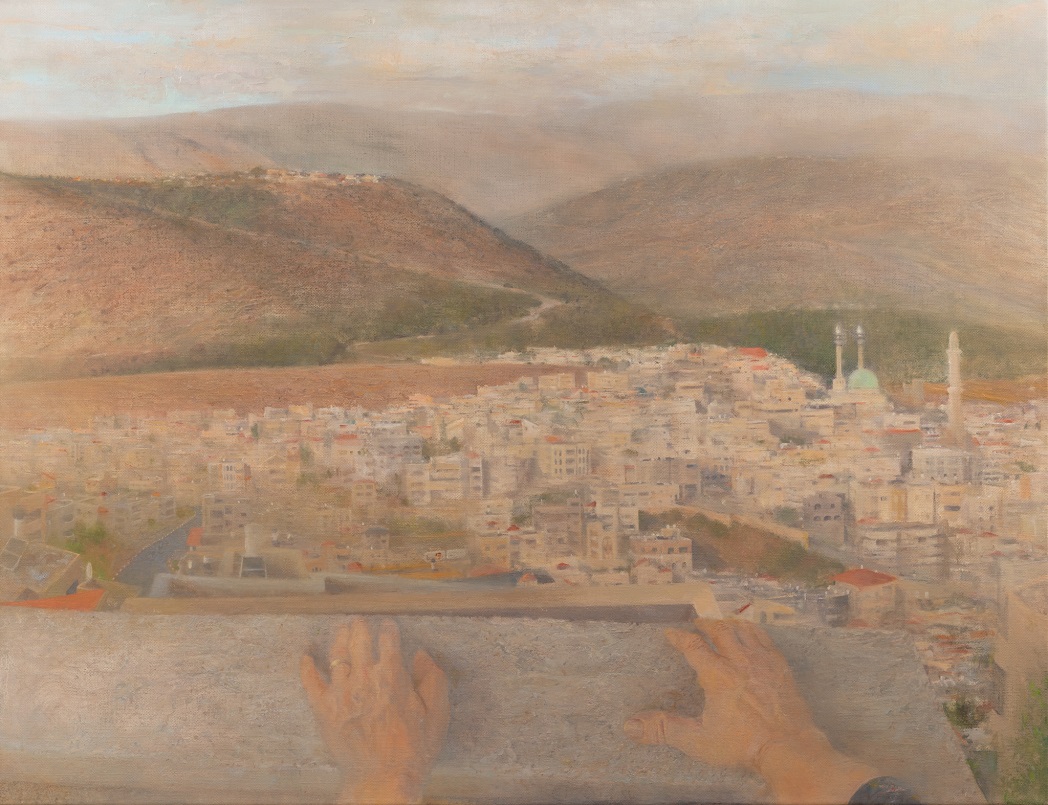 Urban landscape with mountains in background, and hands at bottom up close.