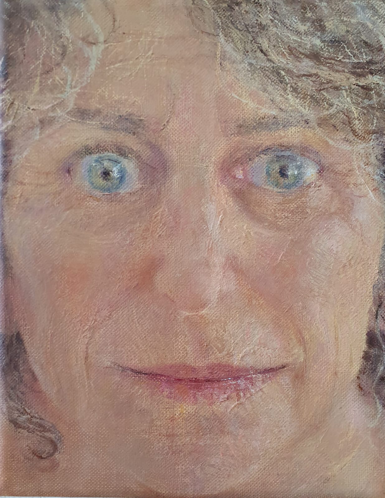 Close-up of artist's face staring straight ahead, with light shining eyes wide open